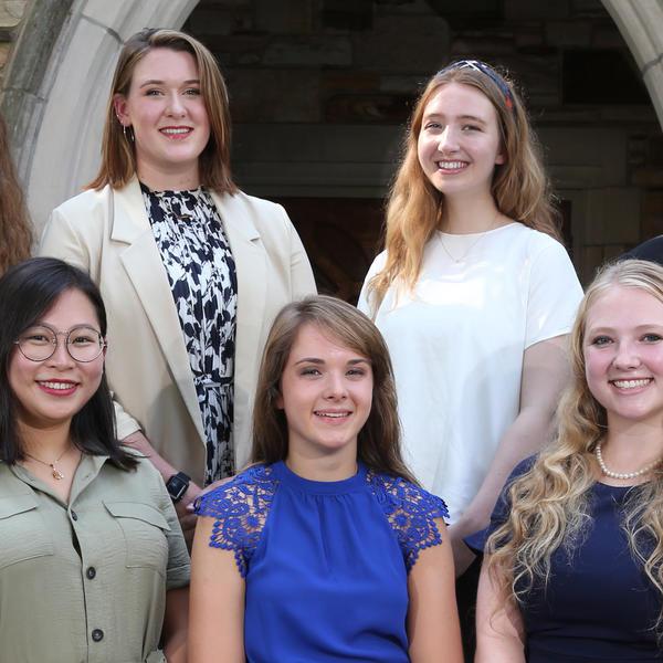 five female students smile at the camera